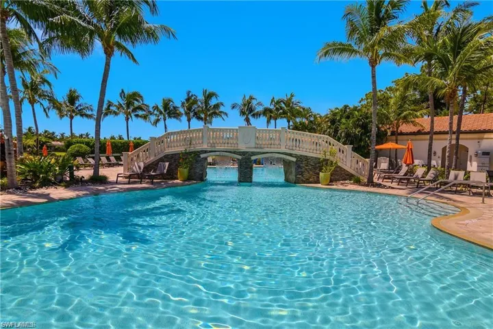 Community pool with stairs and a patio area