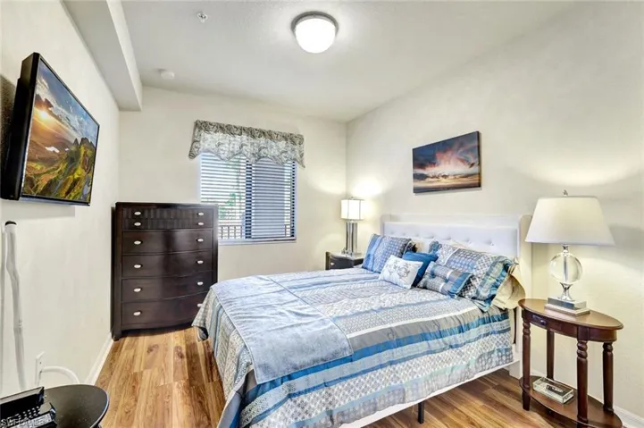 Bedroom featuring light wood-type flooring and baseboards