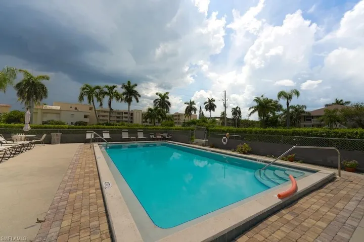 Community pool featuring a patio