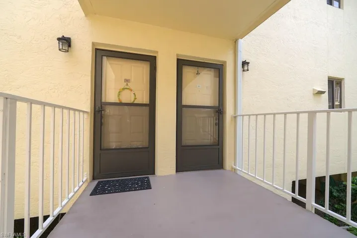 View of exterior entry featuring stucco siding and board and batten siding