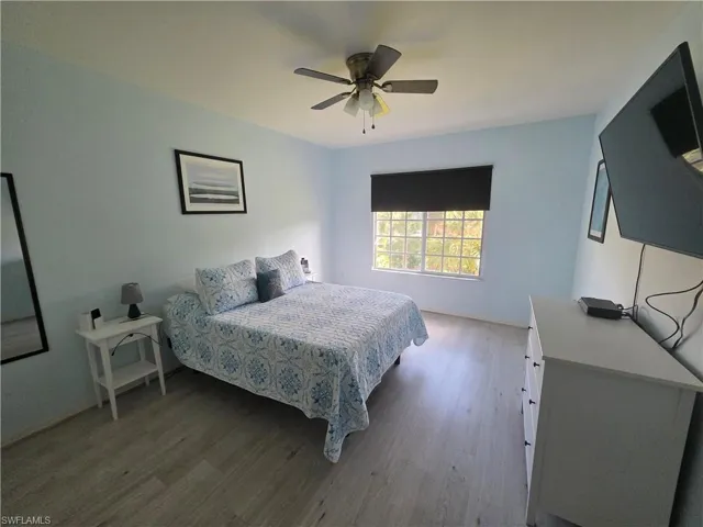 Bedroom with light wood finished floors and ceiling fan