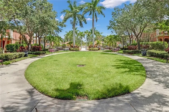 View of property's community with a lawn