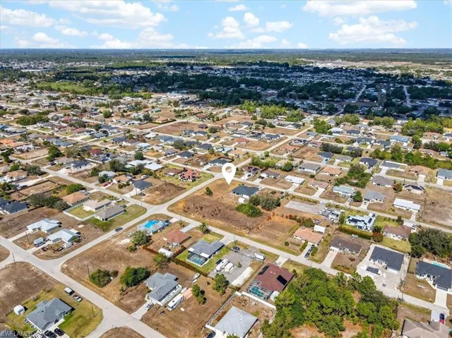 Aerial overview of property's location with nearby suburban area