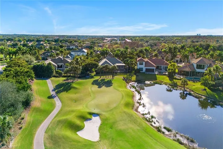Aerial perspective of suburban area with a large body of water and a local golf course