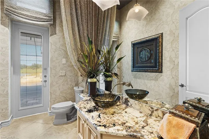Half bath with vanity and light tile patterned flooring