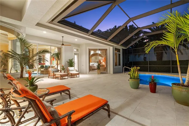 View of patio with an outdoor pool, ceiling fan, glass enclosure, and a sunroom