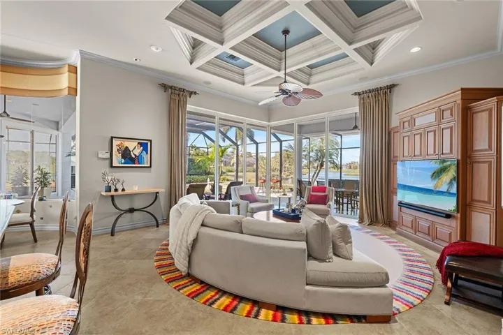 Living area with a ceiling fan, coffered ceiling, recessed lighting, ornamental molding, and beamed ceiling