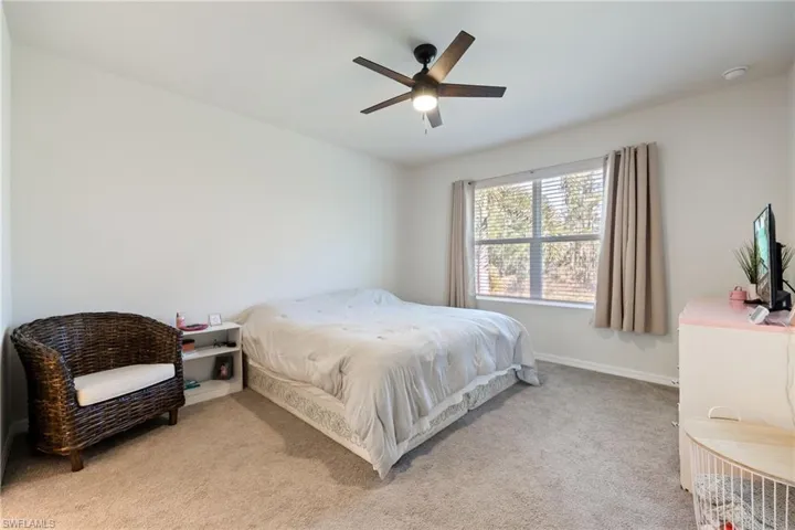 Bedroom featuring carpet and a lit ceiling fan
