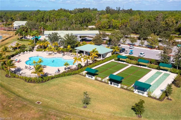 Bird's eye view of a pool area and a heavily wooded area