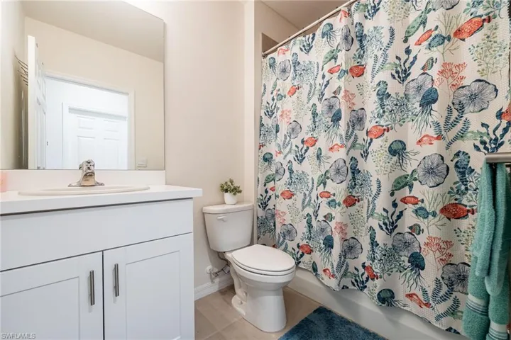 2nd full bathroom featuring vanity and shower / bath combo