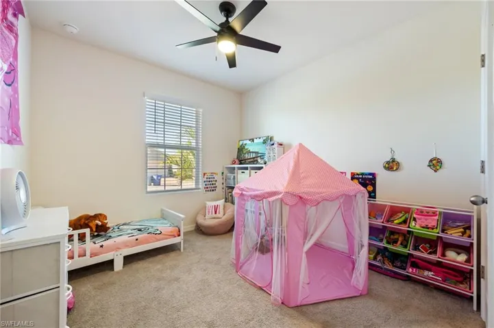 2nd bedroom featuring carpet and lit ceiling fan