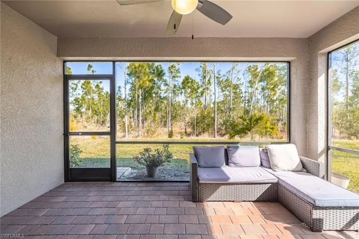 Screened lanai featuring a ceiling fan