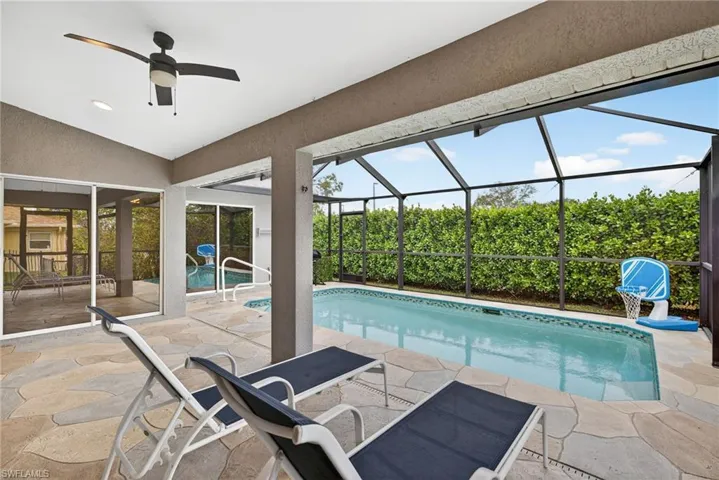 Pool with covered outdoor living space and screened lanai