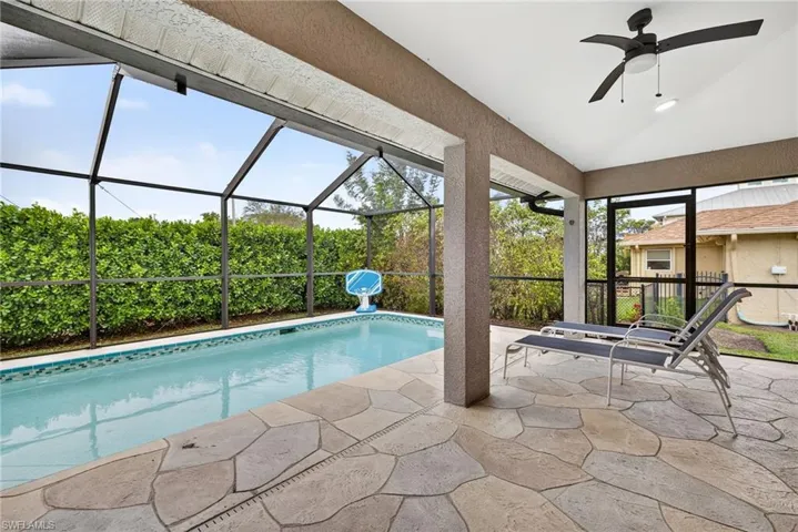 Pool with covered outdoor living space and screened lanai
