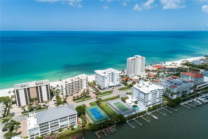 Birds eye view of property with a water view
