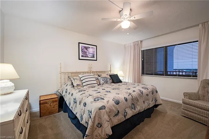 Bedroom featuring ceiling fan and carpet floors