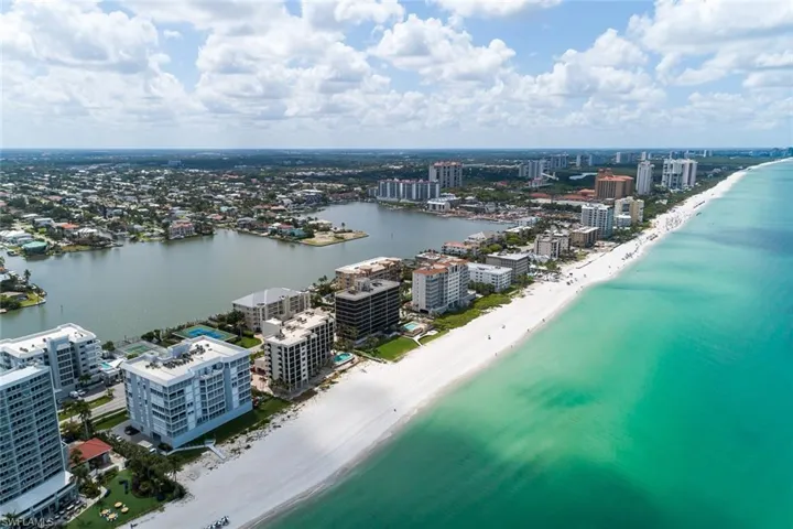 Bird's eye view with a water view and a view of the beach
