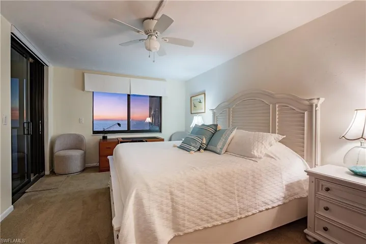 Carpeted bedroom with ceiling fan