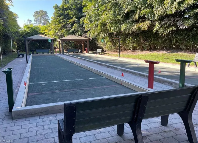 Surrounding community with a bocce ball area, a gazebo, a patio area, and view of scattered trees