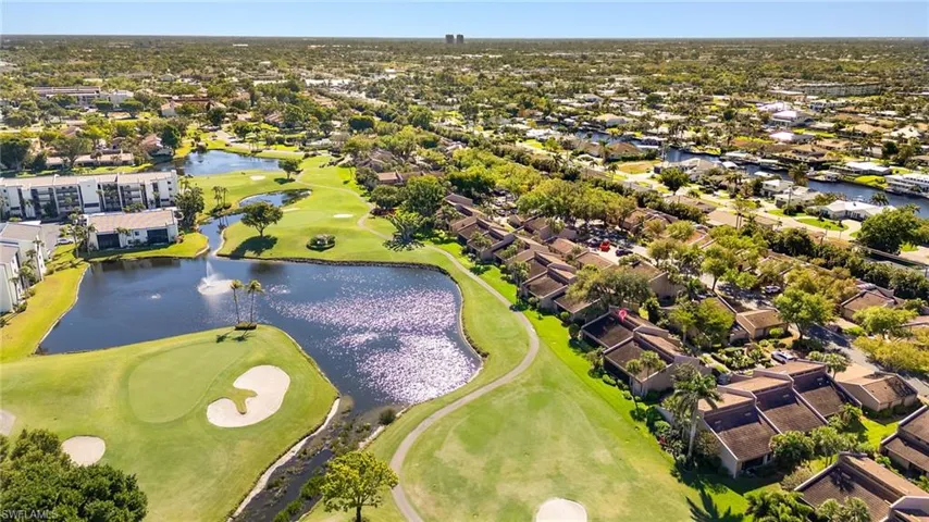 Drone / aerial view with a residential view, golf course view, and a water view