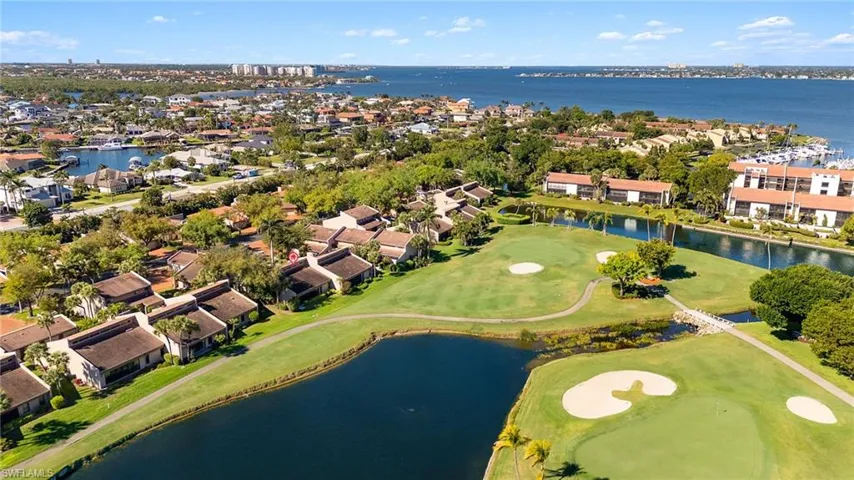 Birds eye view of property featuring a residential view, a water view, and view of golf course