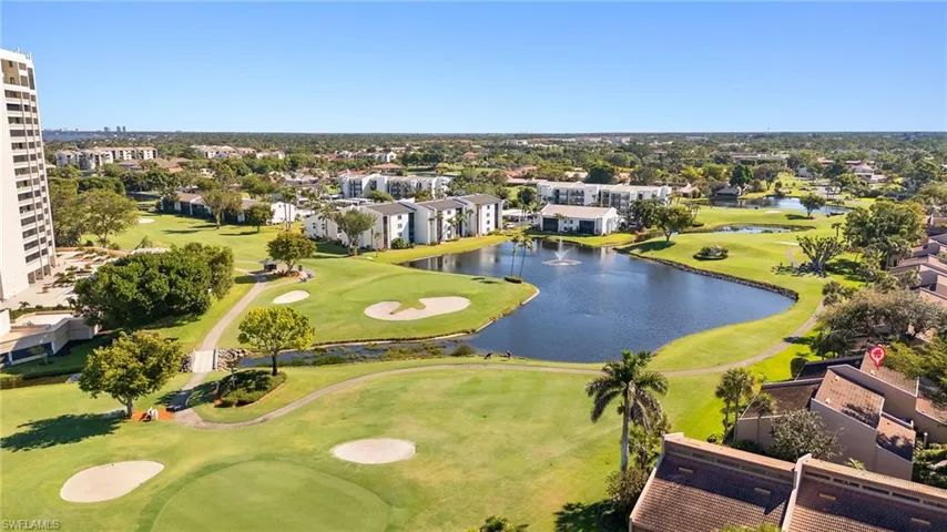 Birds eye view of property featuring a water view and view of golf course