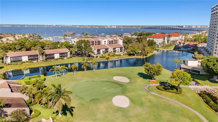 Birds eye view of property featuring a water view and golf course view
