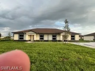 Single story home with a front yard