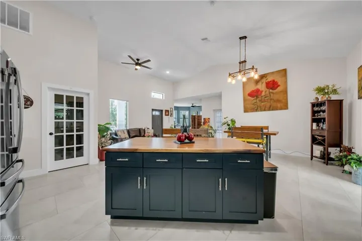 Spacious kitchen island with a wood-finish countertop and dark cabinetry