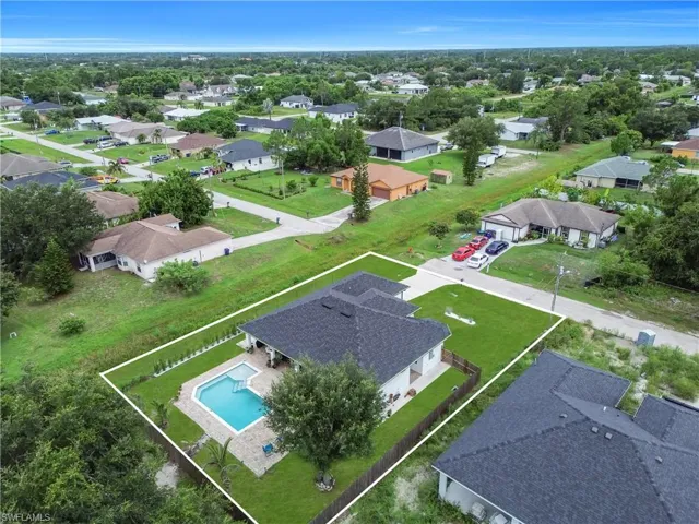 Aerial perspective showcasing a single-story residence with a dark shingle roof