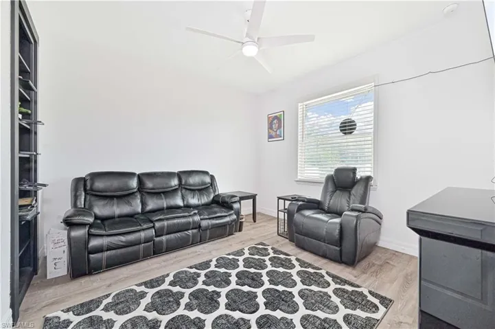 Living room featuring ceiling fan and wood finished floors
