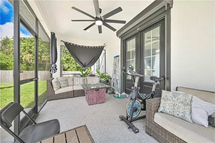 Sunroom / solarium with outdoor lounge area, a ceiling fan, and plenty of natural light