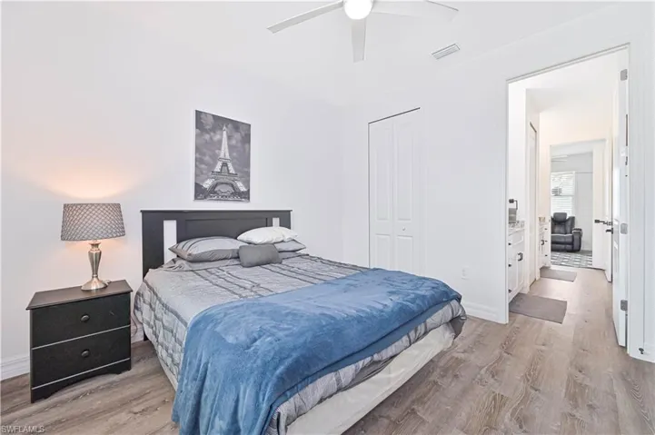 Bedroom featuring light wood-style flooring, a closet, and a ceiling fan