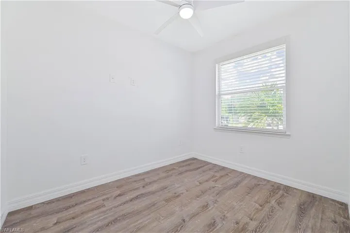 Unfurnished room featuring wood finished floors and ceiling fan