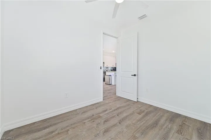 Unfurnished room featuring light wood-style flooring and a ceiling fan