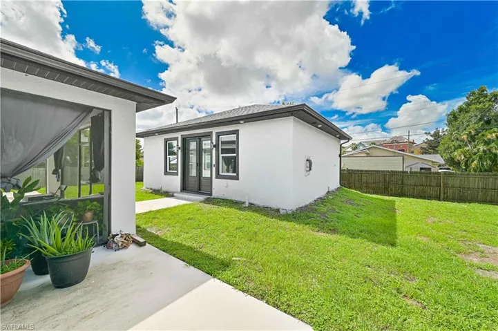 Back of house featuring french doors, stucco siding, and a patio