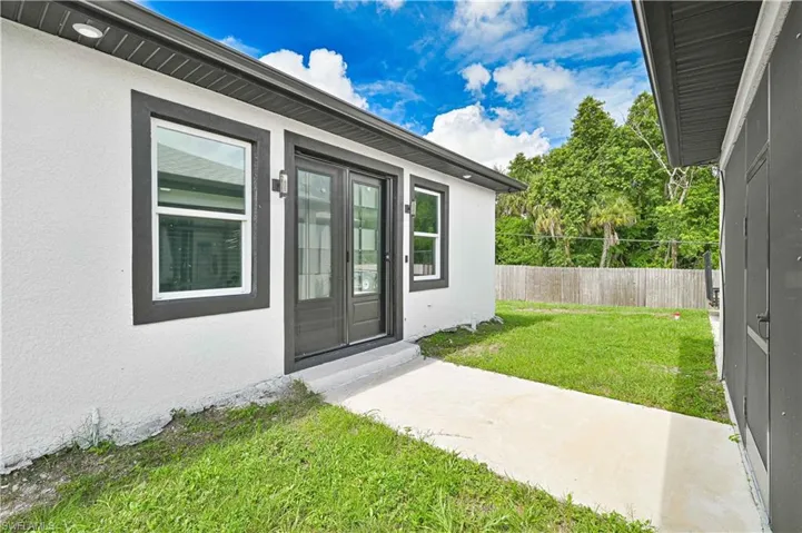 Entrance to property featuring stucco siding
