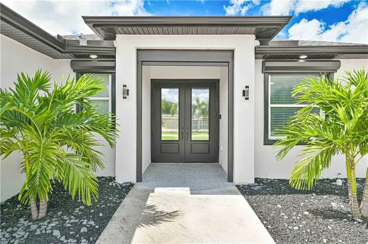 Entrance to property with french doors and stucco siding
