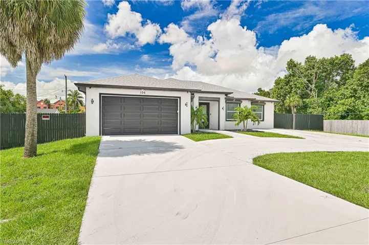 View of front of house featuring concrete driveway, stucco siding, and an attached garage
