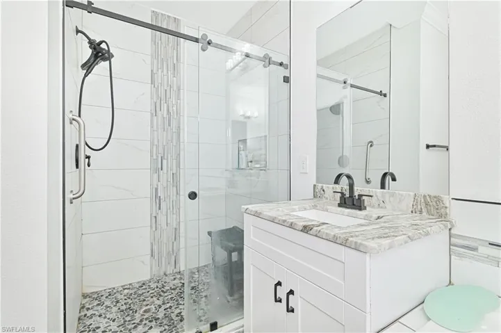 Bathroom with a stall shower and vanity