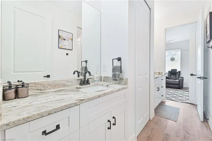 Bathroom featuring vanity and wood finished floors
