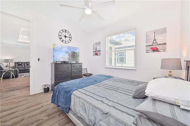 Bedroom with wood finished floors and ceiling fan
