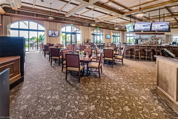 Carpeted dining area featuring plenty of natural light, crown molding, and coffered ceiling
