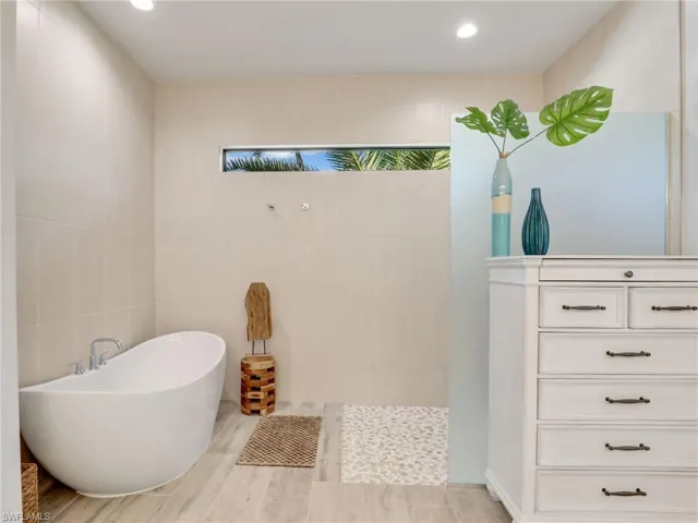 Bathroom with tile walls and a bathtub