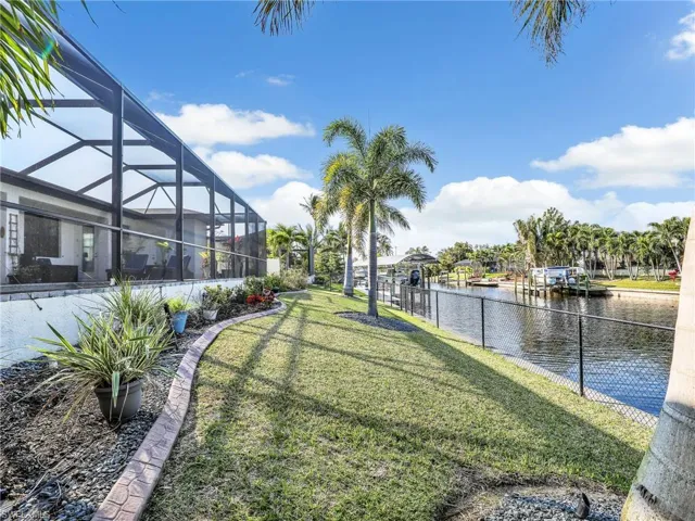 View of yard featuring a water view and a lanai