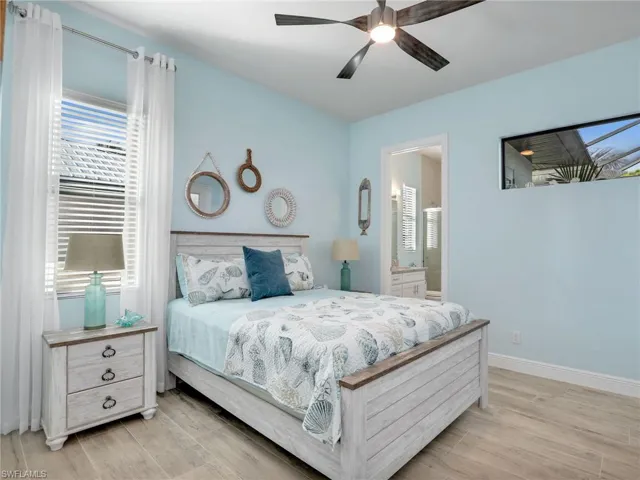 Bedroom with ceiling fan and ensuite bathroom