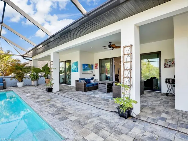 View of patio / terrace with an outdoor hangout area, ceiling fan, and glass enclosure