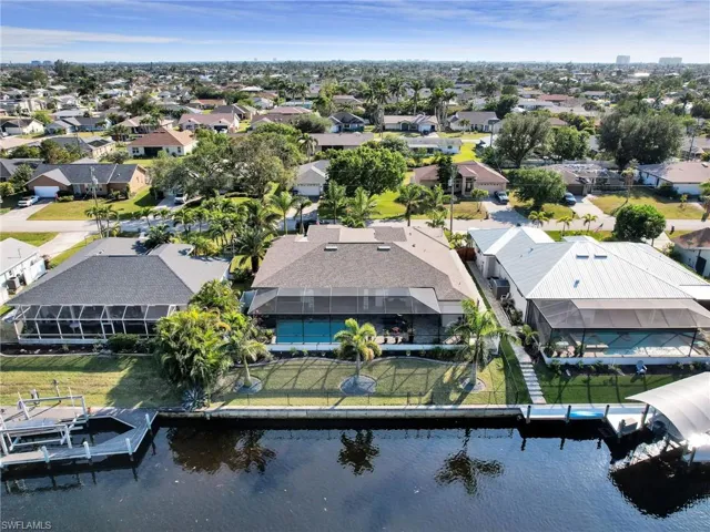 Birds eye view of property with a water view