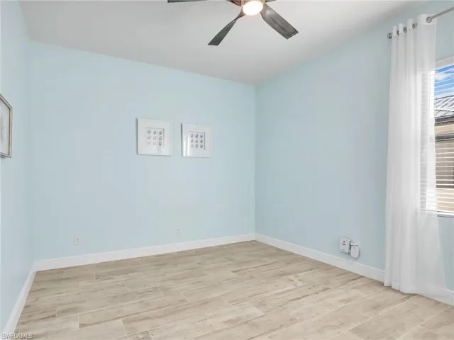 Spare room with ceiling fan and light hardwood / wood-style floors