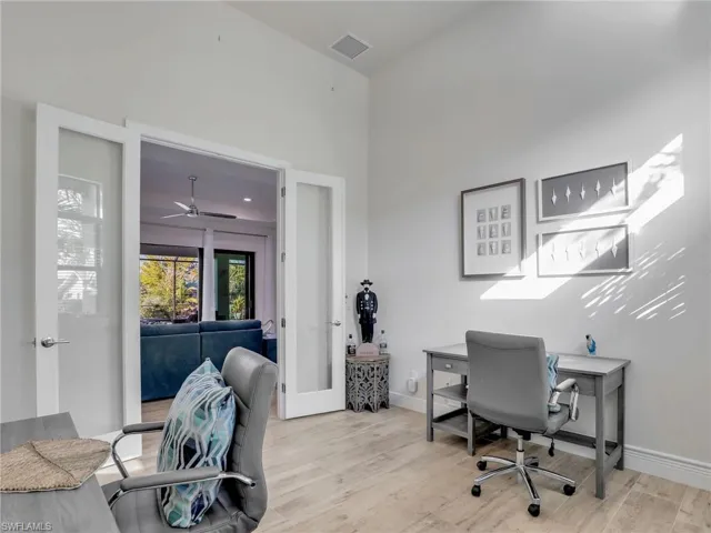 Office featuring light hardwood / wood-style floors and french doors